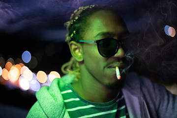 Image showing african american man smiking cigarette  at nigth