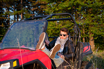 Image showing portrait of young man driving a off road buggy car