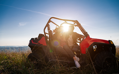 Image showing young couple driving a off road buggy car