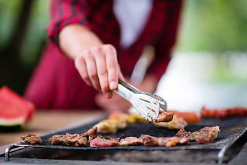 Image showing Man cooking tasty food on barbecue grill