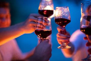 Image showing friends toasting red wine glass during french dinner party outdo