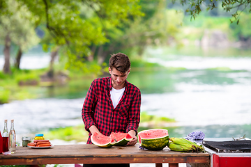 Image showing Man cutting watermelon