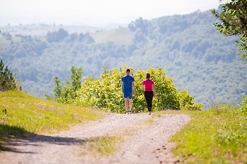 Image showing young couple jogging on sunny day at nature