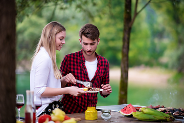 Image showing happy couple having picnic french dinner party outdoor