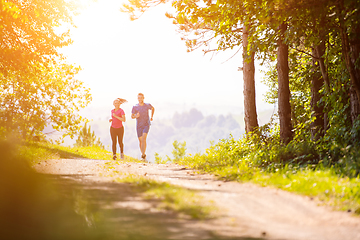 Image showing young couple jogging on sunny day at nature