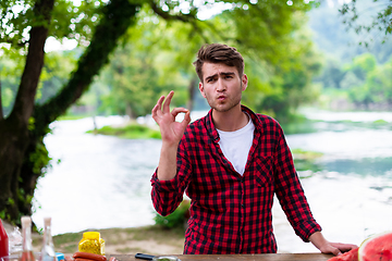 Image showing Man putting spices on raw meat  for barbecue grill