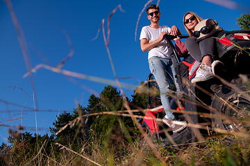 Image showing young couple driving a off road buggy car