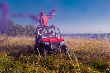 Image showing group of young people having fun while driving a off road buggy 