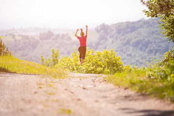 Image showing young woman jogging on sunny day at nature