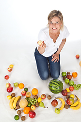Image showing Blond cute woman eating an apple