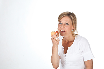 Image showing Blond cute woman eating an apple