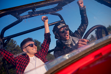 Image showing two young men driving a off road buggy car