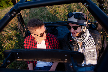 Image showing two young men driving a off road buggy car