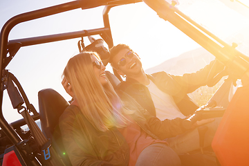 Image showing young couple driving a off road buggy car