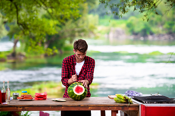 Image showing Man cutting watermelon