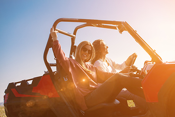 Image showing two young women driving a off road buggy car