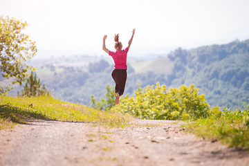 Image showing young woman jogging on sunny day at nature