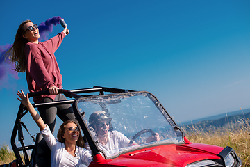 Image showing group of young people having fun while driving a off road buggy 