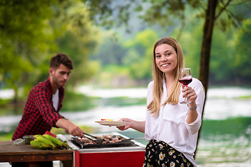 Image showing happy couple having picnic french dinner party outdoor