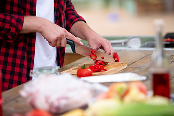 Image showing Man cutting vegetables for salad or barbecue grill