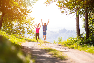 Image showing young couple jogging on sunny day at nature