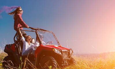 Image showing group of young people having fun while driving a off road buggy 