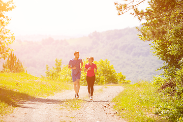 Image showing young couple jogging on sunny day at nature