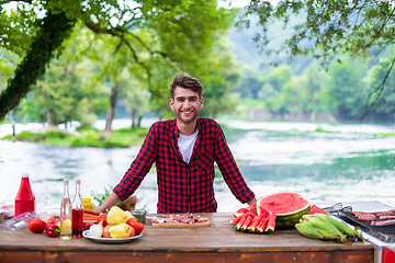 Image showing Man putting spices on raw meat  for barbecue grill