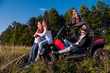 Image showing group of young people driving a off road buggy car