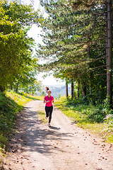 Image showing young woman jogging on sunny day at nature