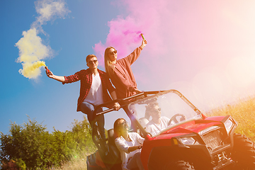 Image showing group of young people having fun while driving a off road buggy 