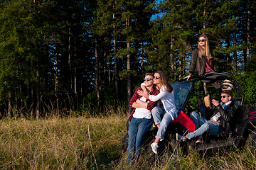 Image showing group of young people driving a off road buggy car