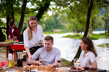 Image showing happy friends having picnic french dinner party outdoor