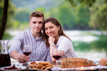 Image showing happy couple having picnic french dinner party outdoor