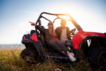 Image showing young couple driving a off road buggy car