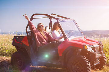 Image showing two young women driving a off road buggy car