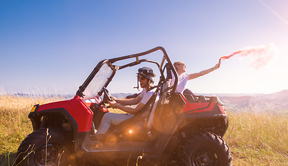 Image showing group of young people having fun while driving a off road buggy 