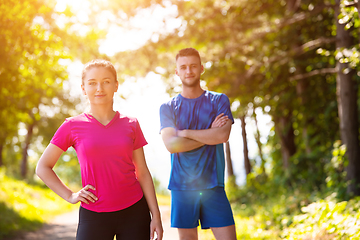 Image showing portrait of young couple jogging on sunny day at nature