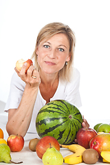 Image showing Blond cute woman eating an apple