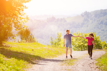 Image showing young couple jogging on sunny day at nature