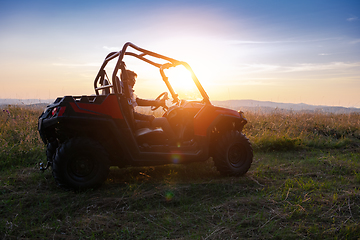 Image showing portrait of young man driving a off road buggy car