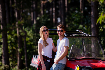Image showing young couple driving a off road buggy car
