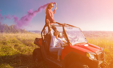 Image showing group of young people having fun while driving a off road buggy 