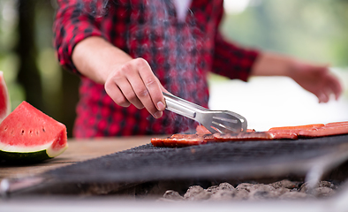 Image showing Man cooking tasty food on barbecue grill