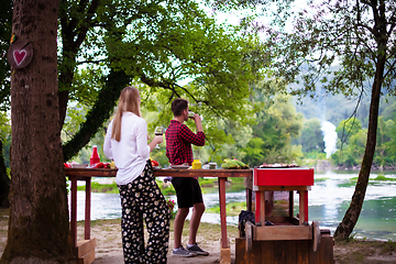 Image showing happy couple having picnic french dinner party outdoor