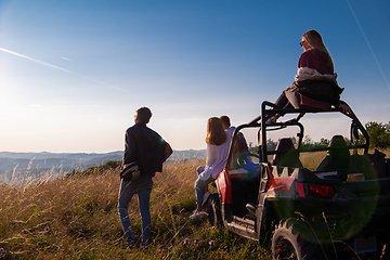 Image showing group of young people driving a off road buggy car