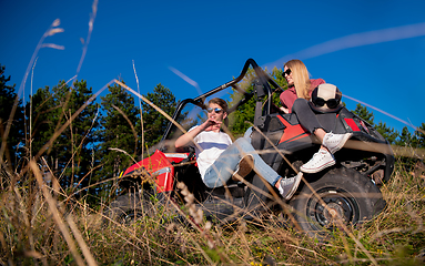 Image showing young couple driving a off road buggy car