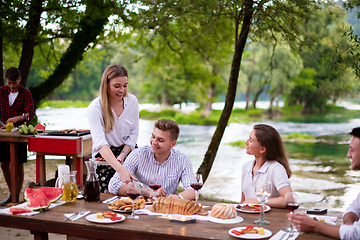 Image showing happy friends having picnic french dinner party outdoor