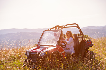 Image showing two young women driving a off road buggy car