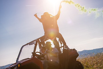 Image showing group of young people having fun while driving a off road buggy 